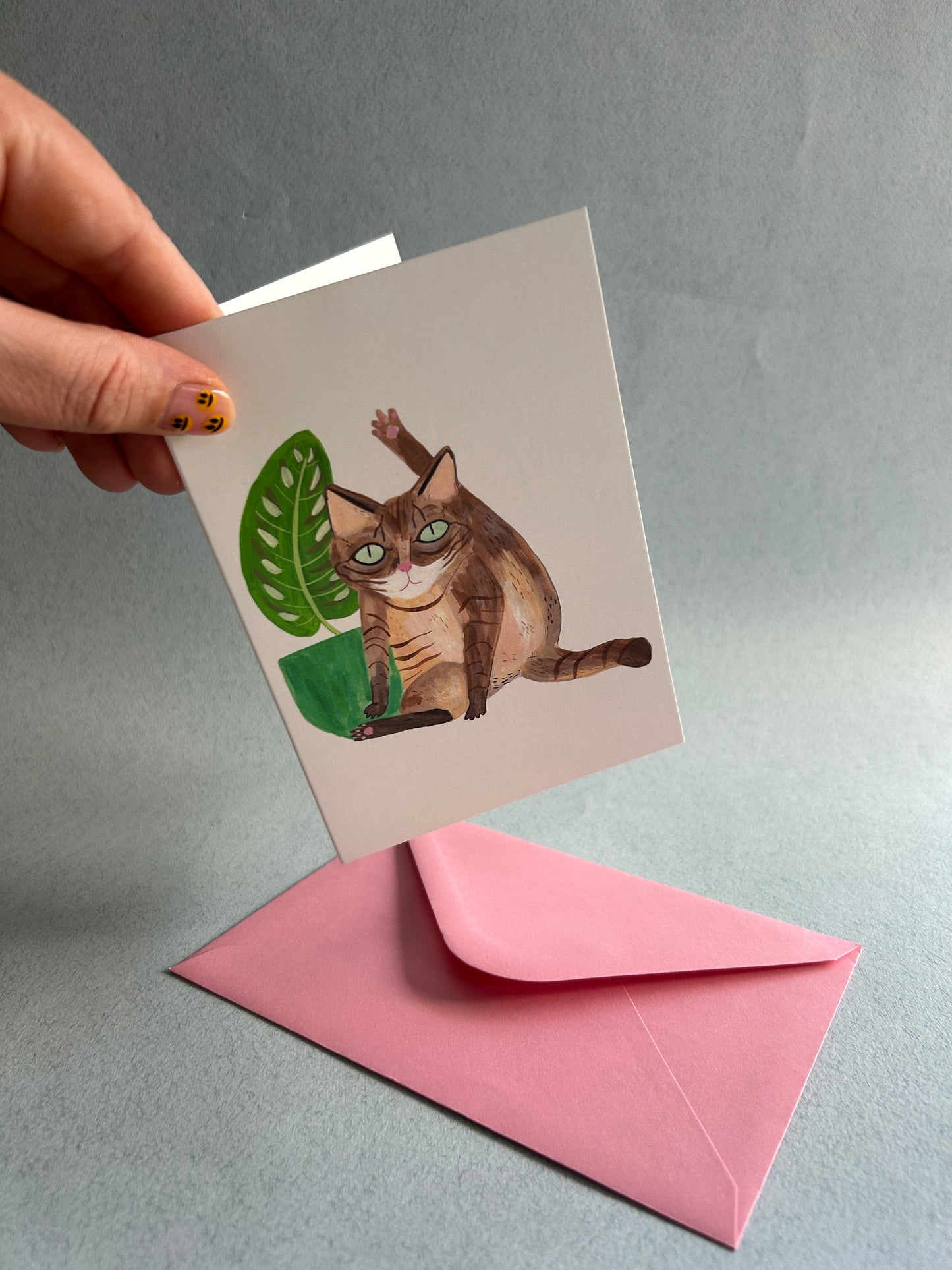 Cat licking Greetings Card