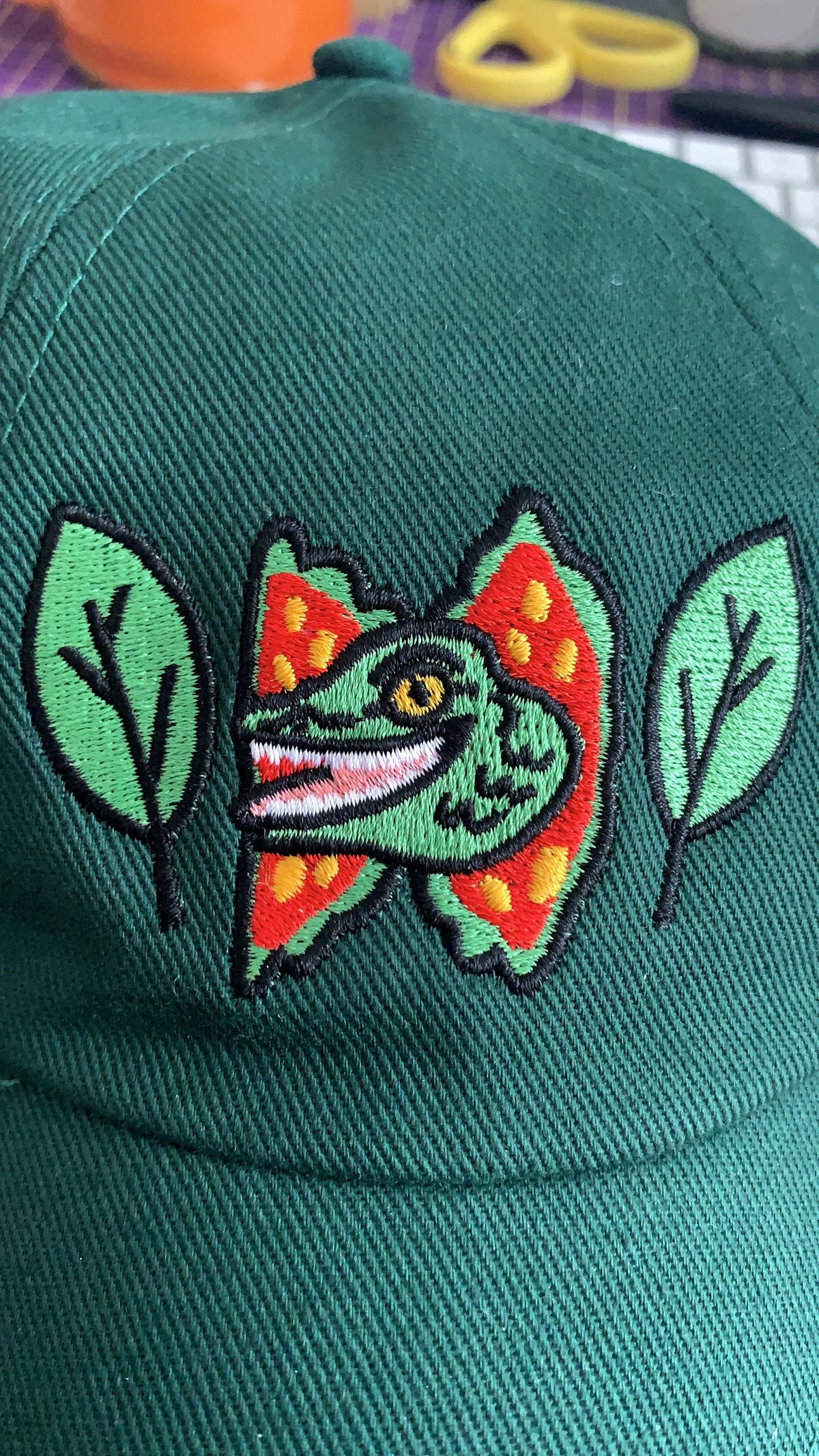 Happy Dilophosaurus Dinosaur embroided cotton drill CAP with leaves inspired by Jurassic Park in Forest (Dark) Green - Fernandes Makes